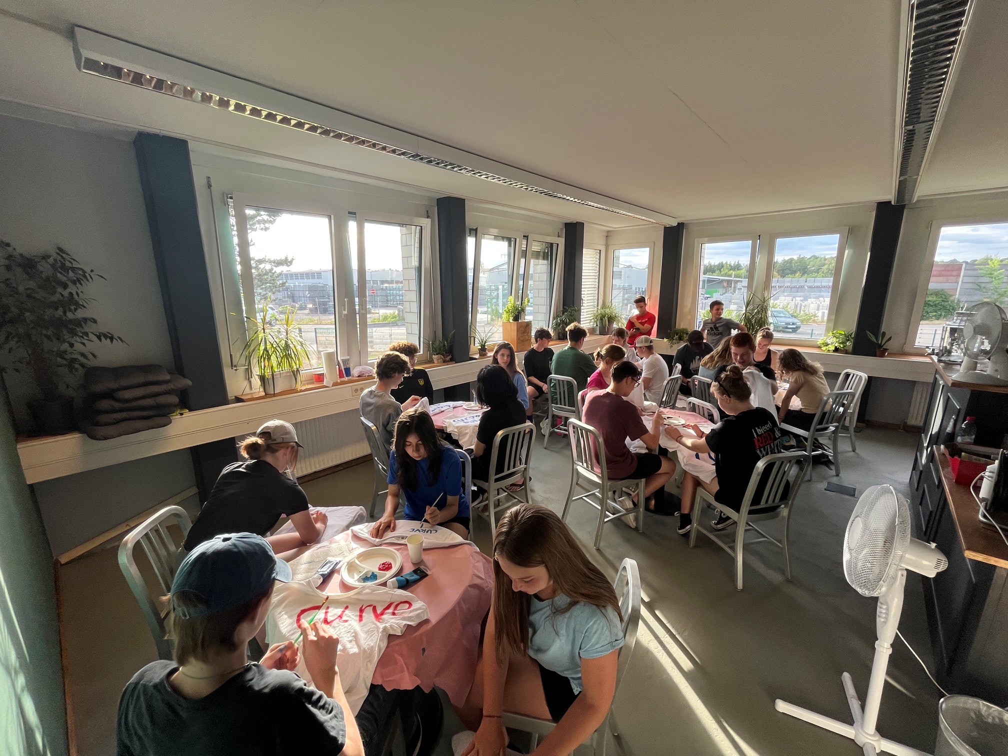 Young people creating shirts together during a workshop