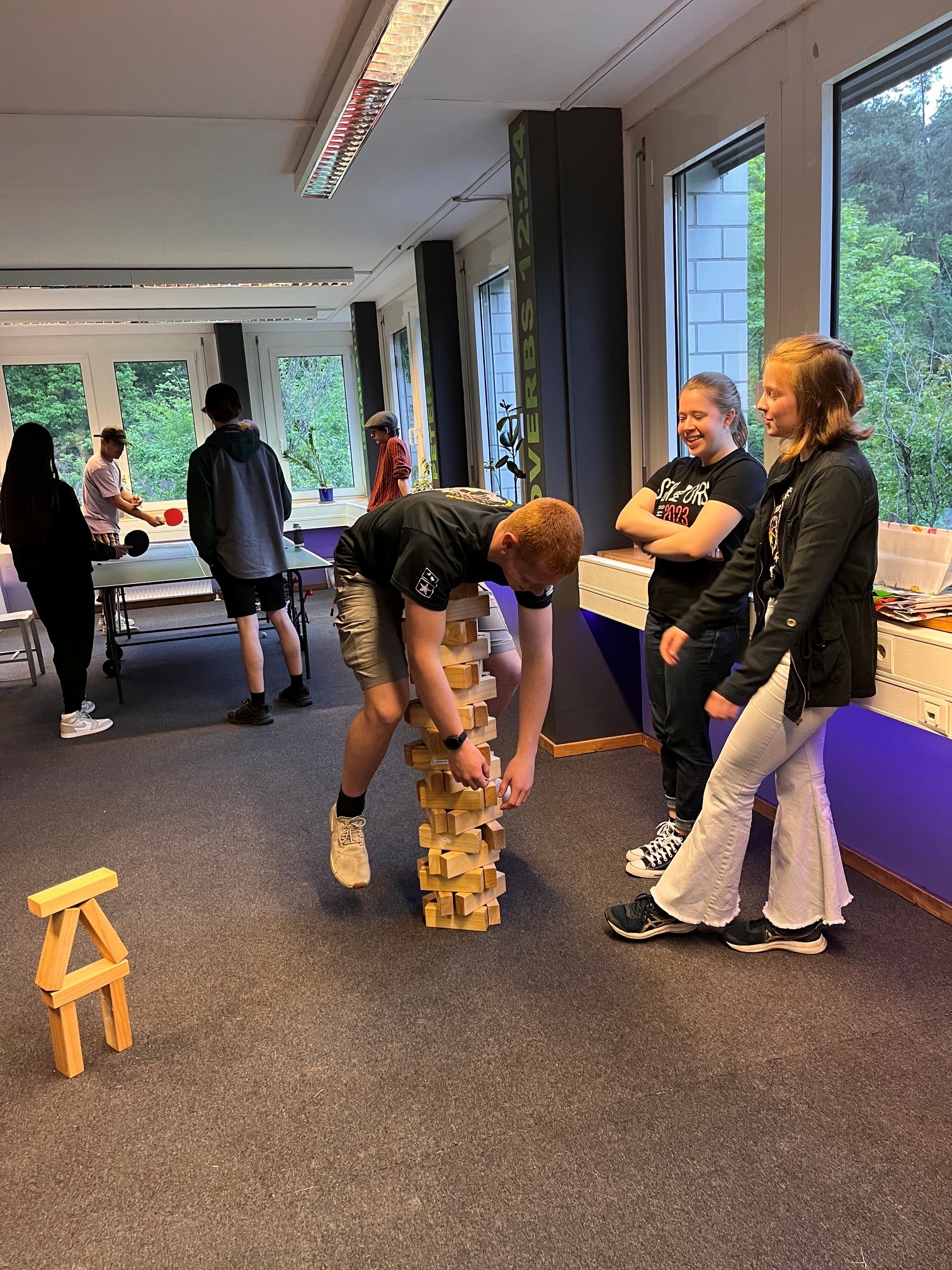 Friends playing a large stacking game