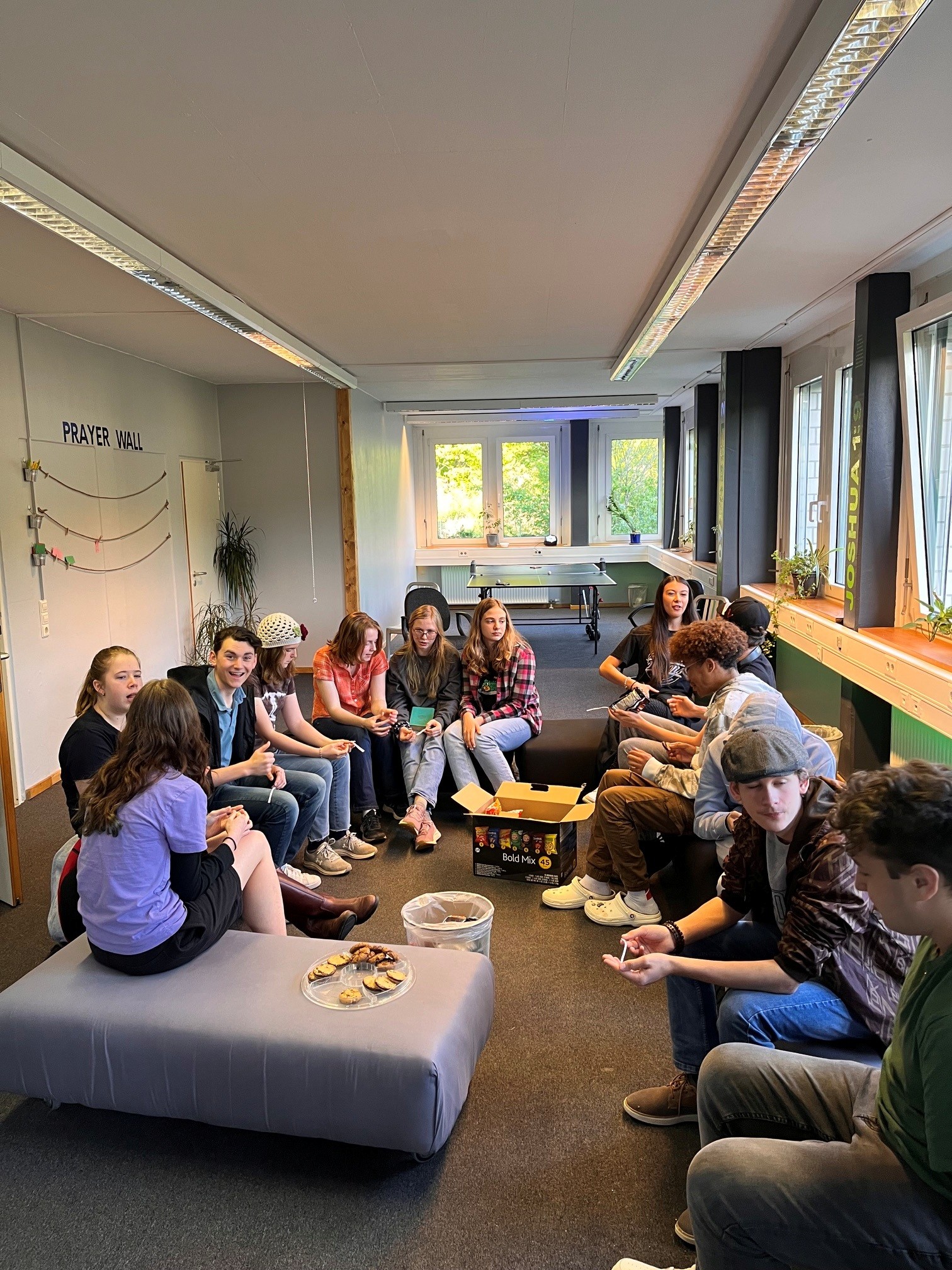Young people gathered near a prayer wall