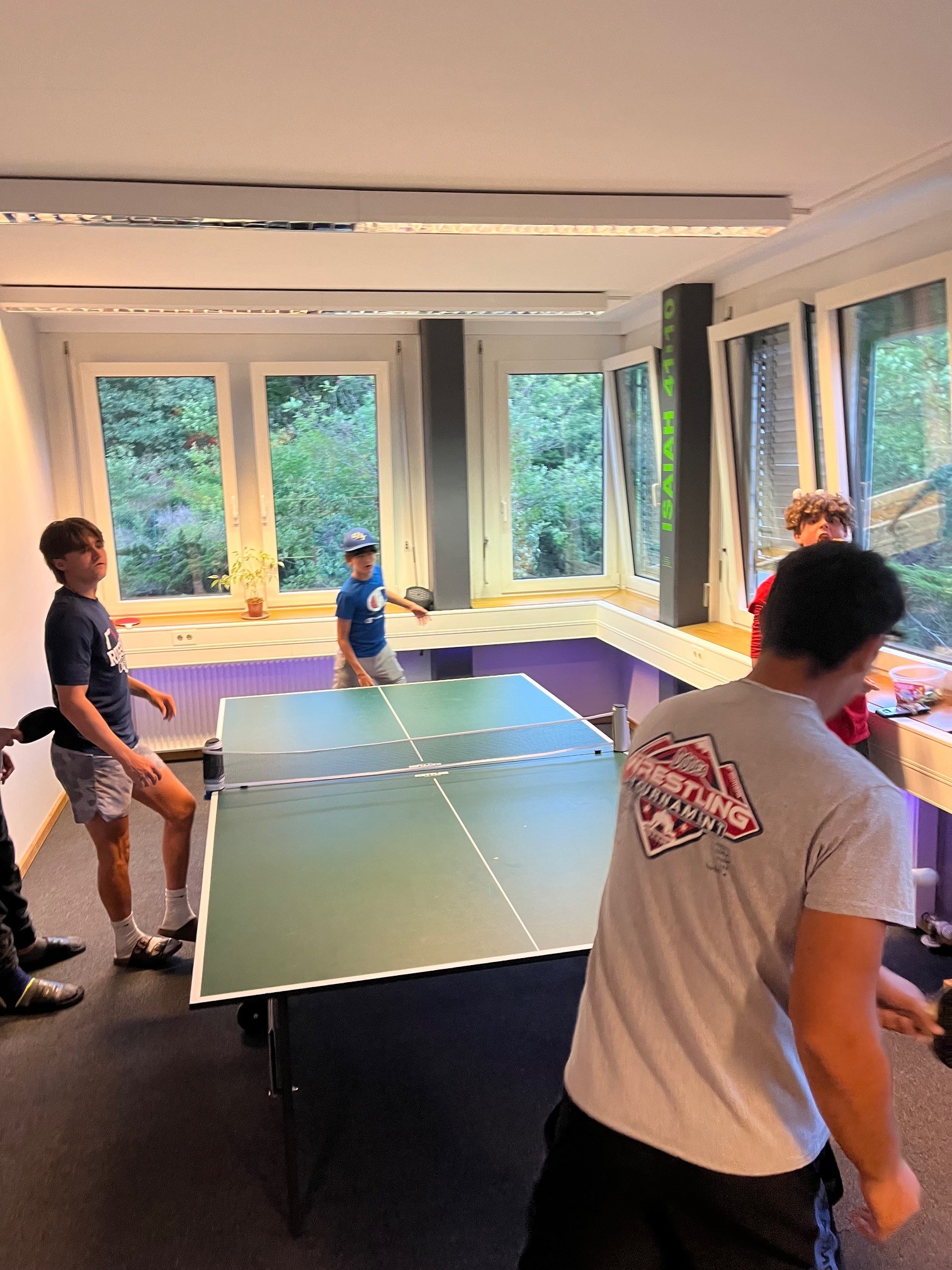 Young people playing table tennis together